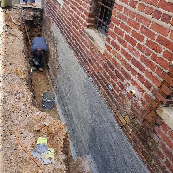 Worker fixing house foundation