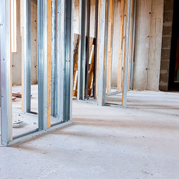 Frame for plasterboard wall, mounted vertical metal and wooden profiles, work in progress of unfinished edifice